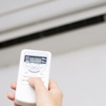 Hand of woman includes air-conditioner metz